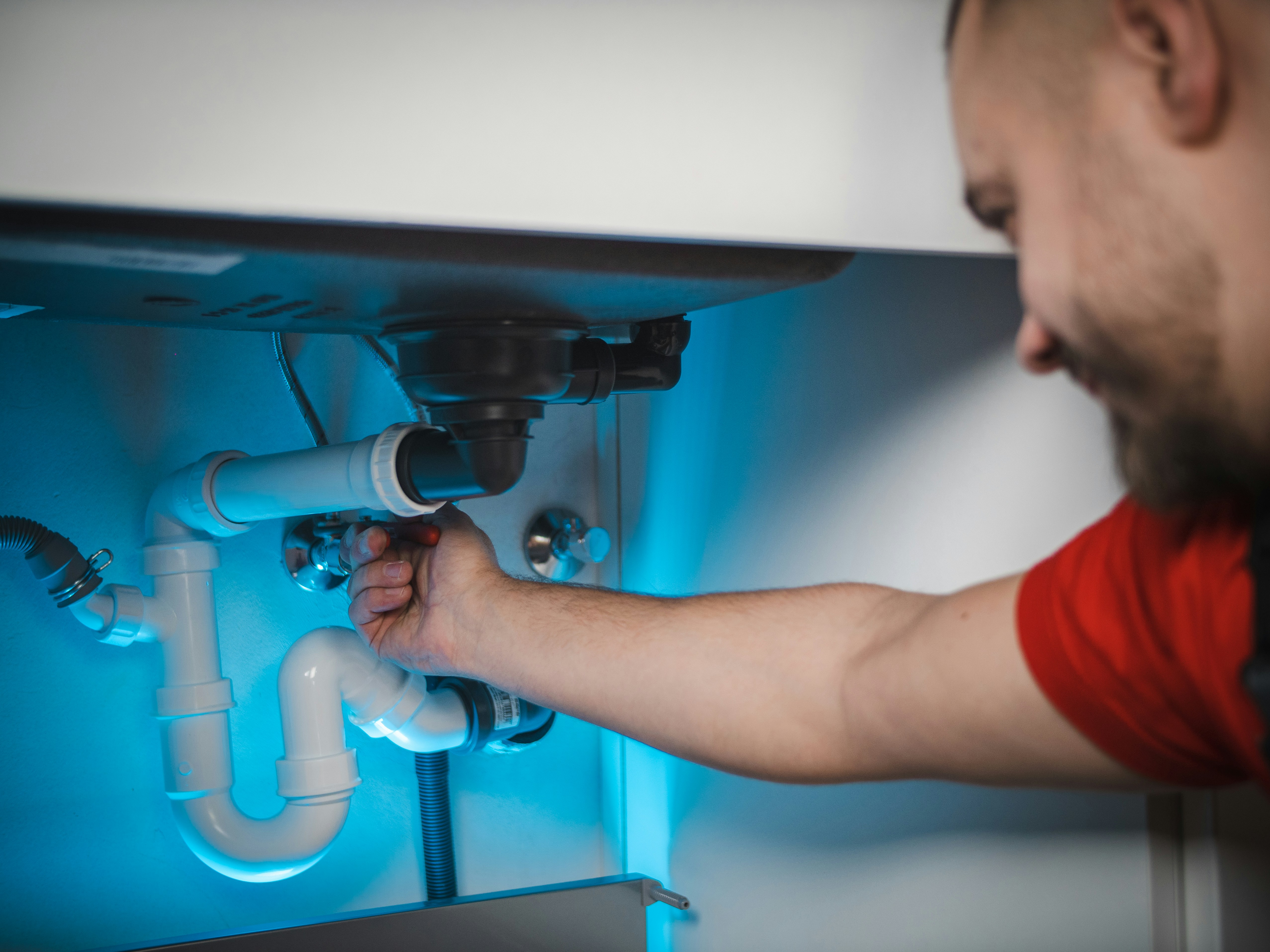 Professional plumber working on emergency repairs